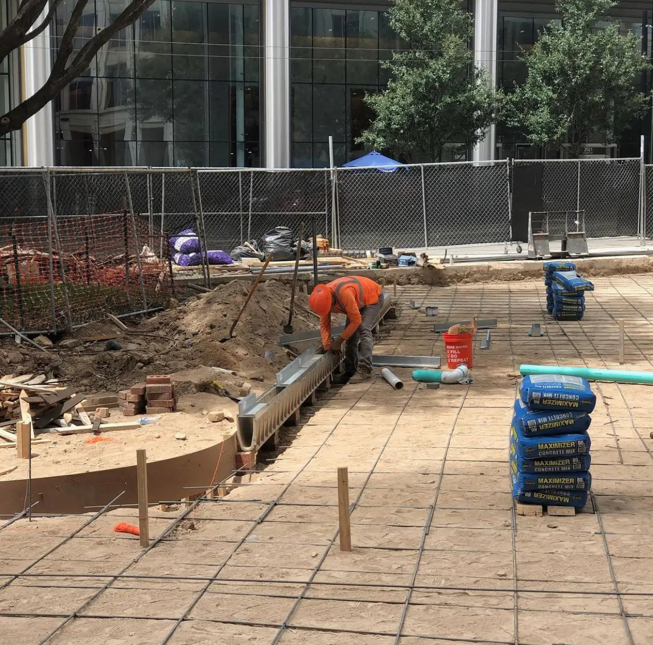 construction worker working on a trench drain system installation